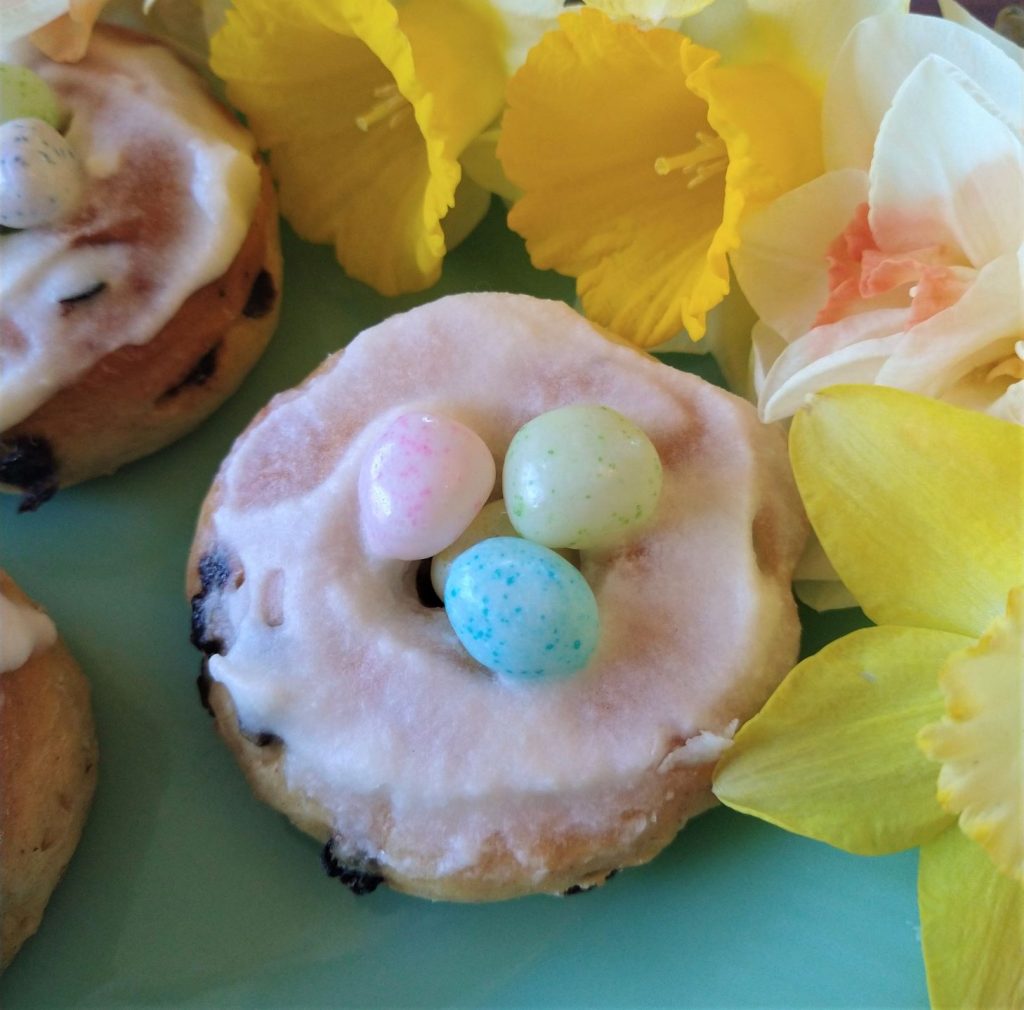 Sweet roll with jelly beans surrounded by daffodils