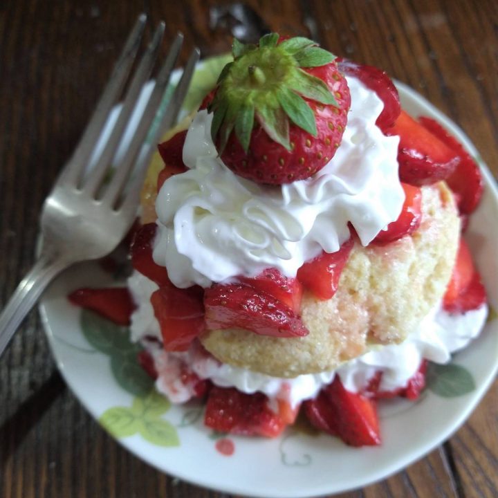 citrus strawberry shortcake on a plate with a fork