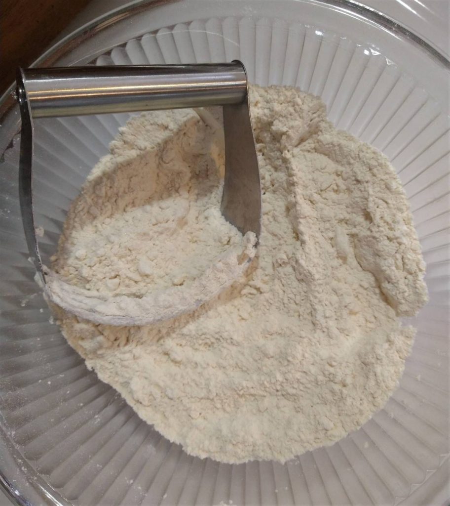 flour mixture with a pastry cutter in a glass bowl