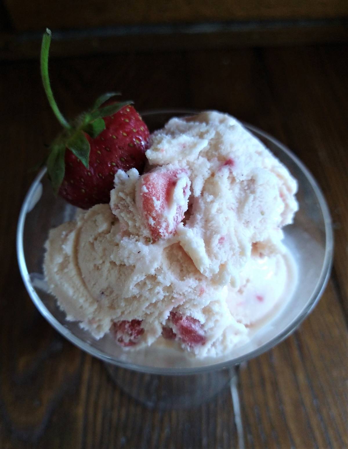 strawberry ice cream in glass garnished with fresh strawberry