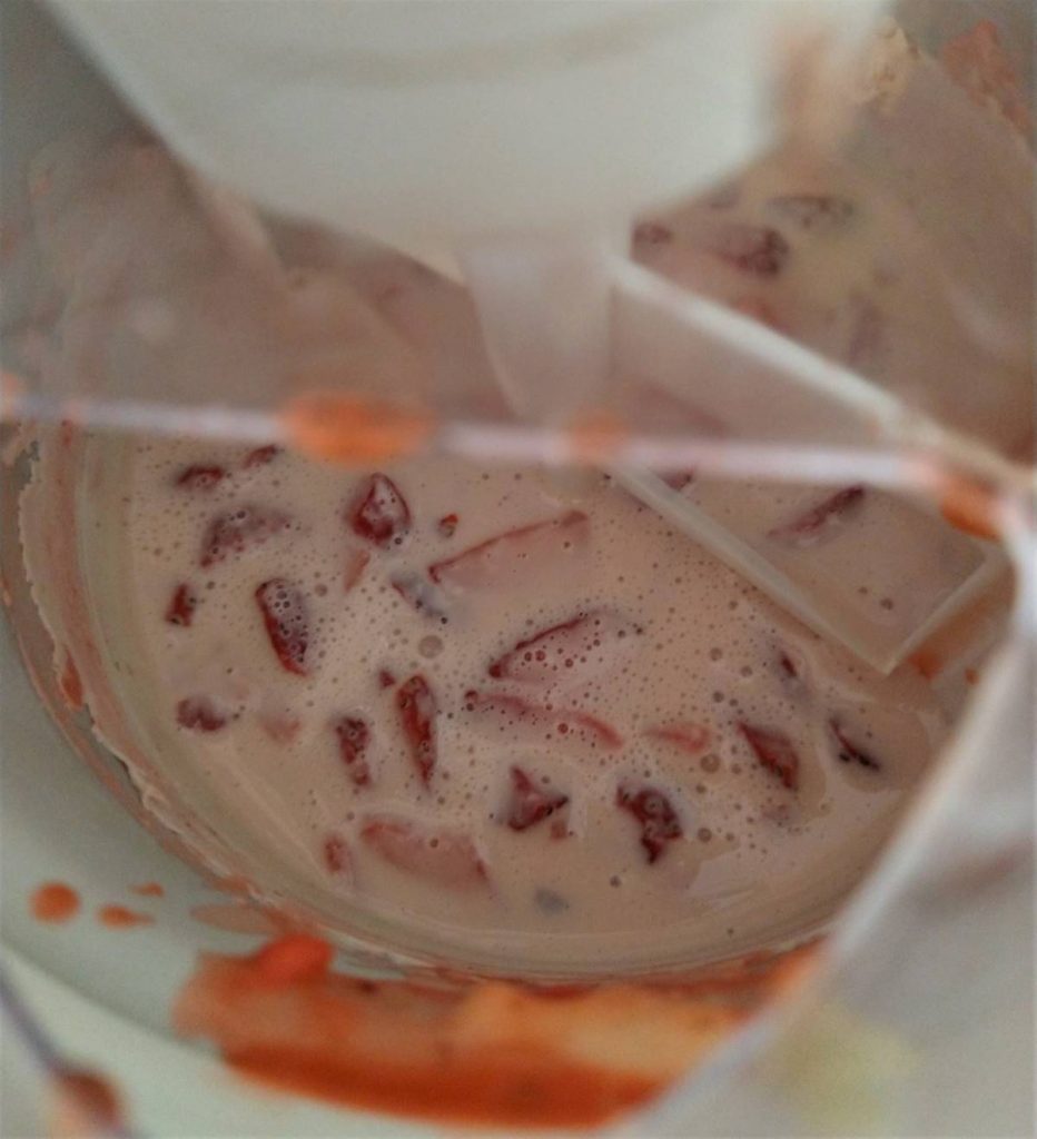 strawberry ice cream mixture in an ice cream mixer