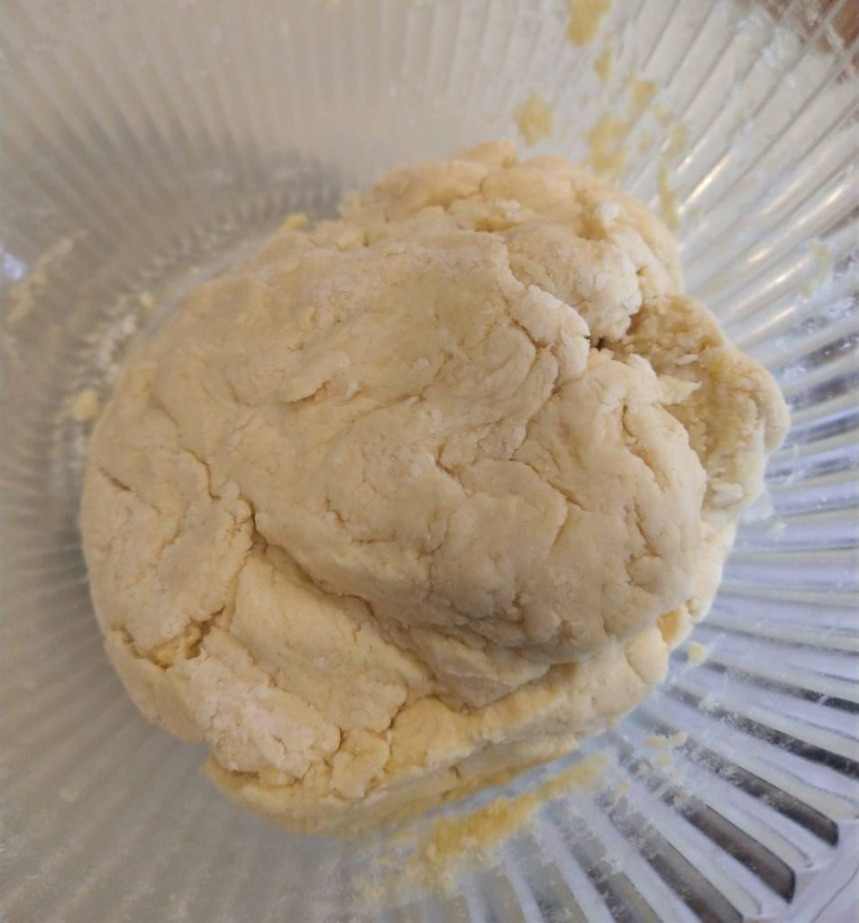 ball of biscuit dough in glass bowl