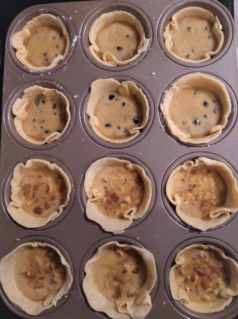 unbaked maple butter tarts in muffin tin