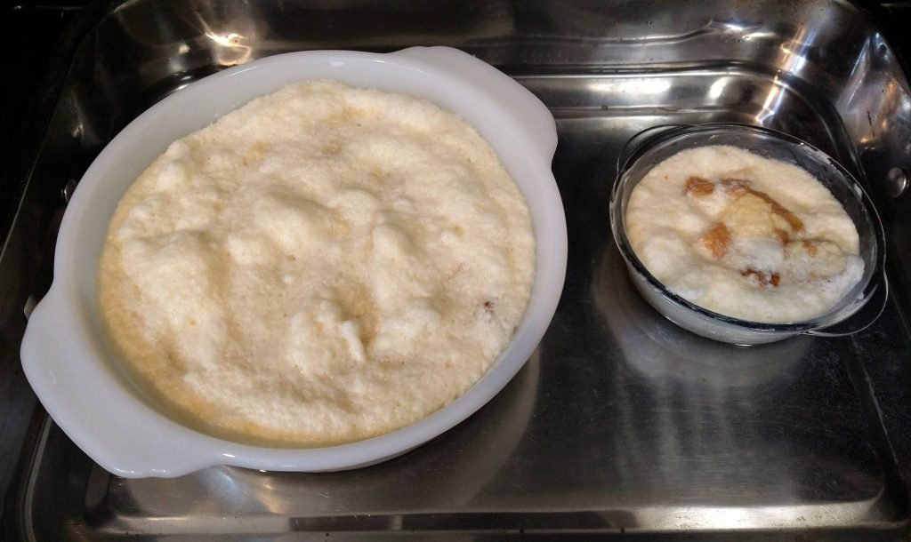 maple bread pudding batter in two glass dishes sitting in a water bath and stainless steel pan
